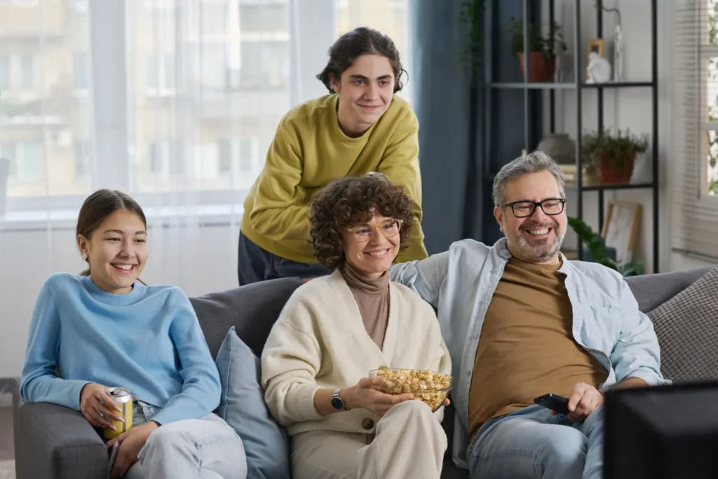 A family enjoying crystal-clear, buffer-free streaming TV in their living room, powered by a high-speed fiber internet connection.